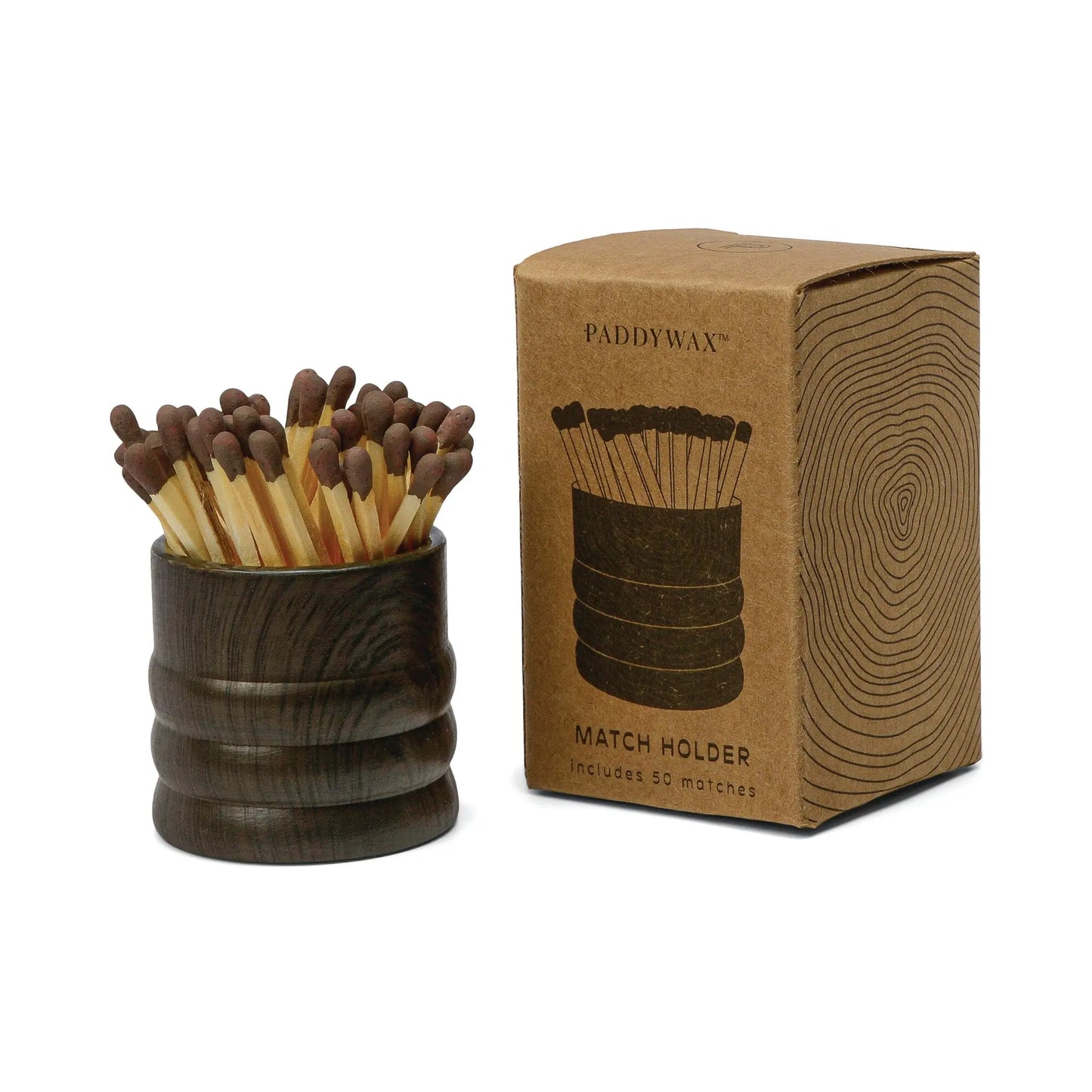 The Dark Brown Ceramic Wood Match Holder, filled with matches, sits beside its brown Paddywax Match Holder box, which displays a tree ring design and product illustration.