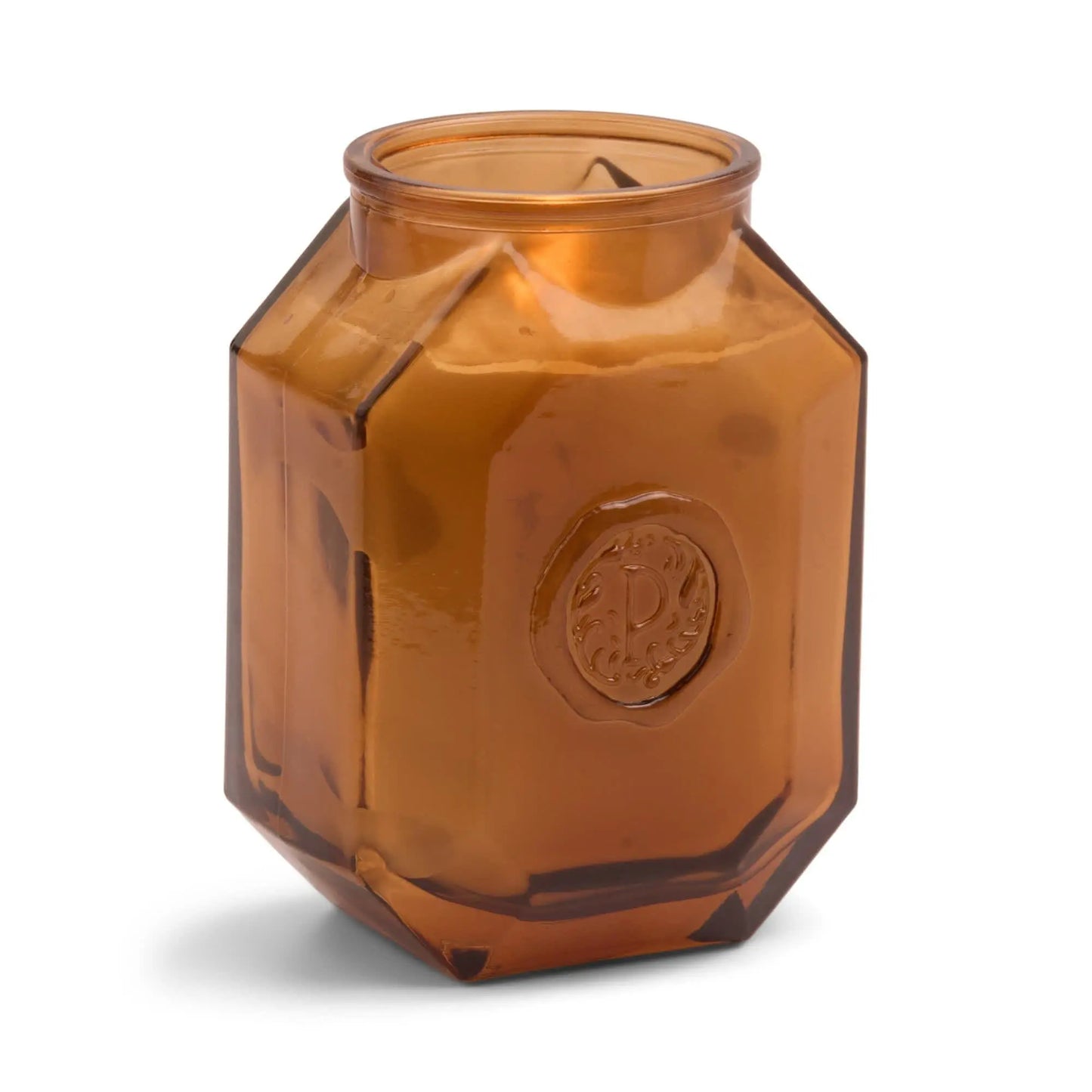 Amber-colored hexagonal glass jar with embossed circular pattern on the front, photographed against a white background—ideal for candles like the Botanica Candle - Leather + Smoke or as part of the Luxurious Botanica Collection.