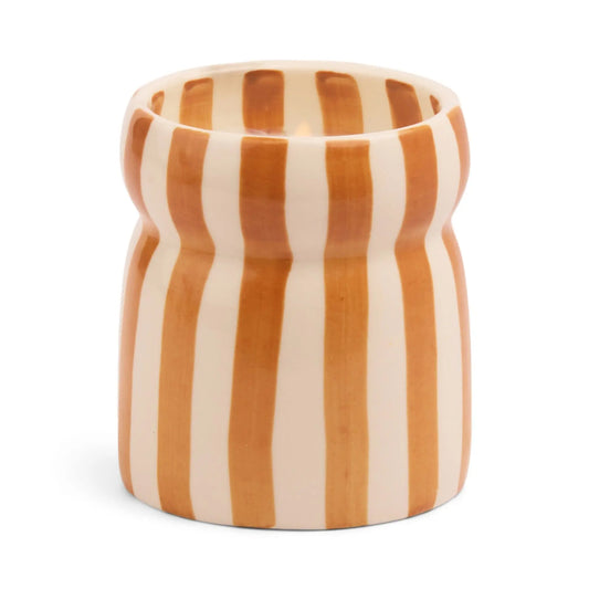 A food-safe ceramic Cabana Rust Candle in Sienna Sunset, featuring a fluted rim and vertical orange and white stripes.