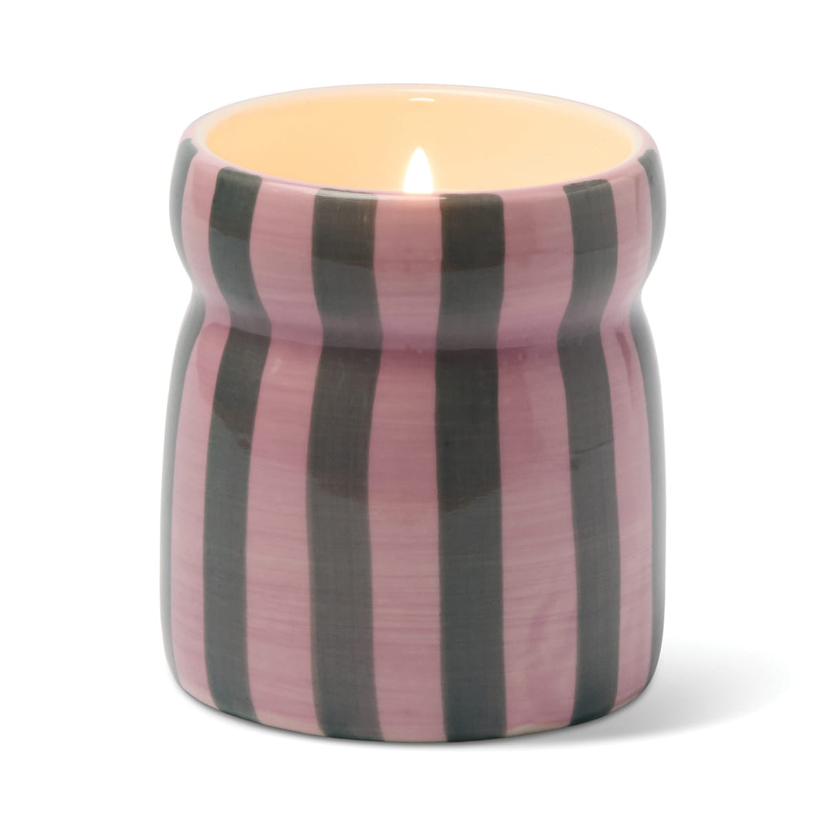 A Cinnamon & Clove - Cabana 6.5 oz Candle glows in a pink and gray striped ceramic holder with a glossy finish, photographed against a white background.