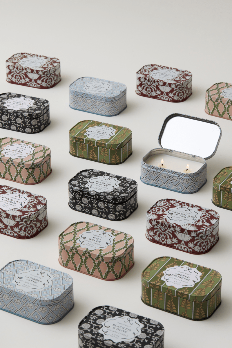 Decorative tin candles with various patterns on a white background