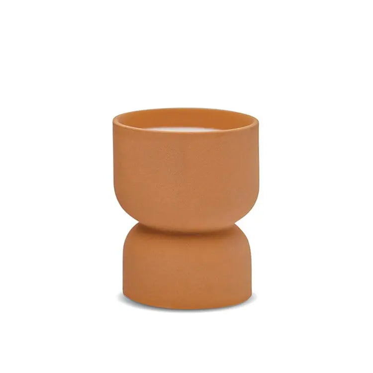 The Form 6oz. Burnt Sienna Matte Hourglass Ceramic Wild Fig & Vetiver cup features a modern, geometric design and matte brown finish, showcased elegantly against a plain white background.