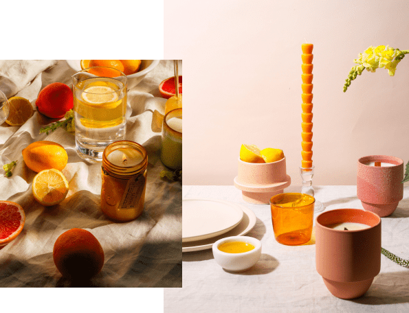 Two tabletop scenes: One with citrus fruits, a candle, and a glass of water on a cloth; the other with ceramic dishes, a tall candle, flowers, and an amber glass on a peach background.