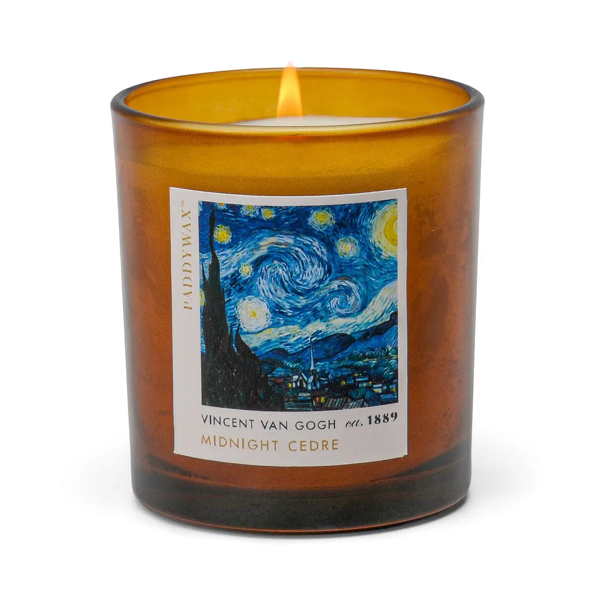 The Impressionist Candle - Vincent Midnight Cedre is a lit brown glass candle with a label featuring Van Goghs The Starry Night and text reading Vincent Van Gogh, Midnight Cedre.