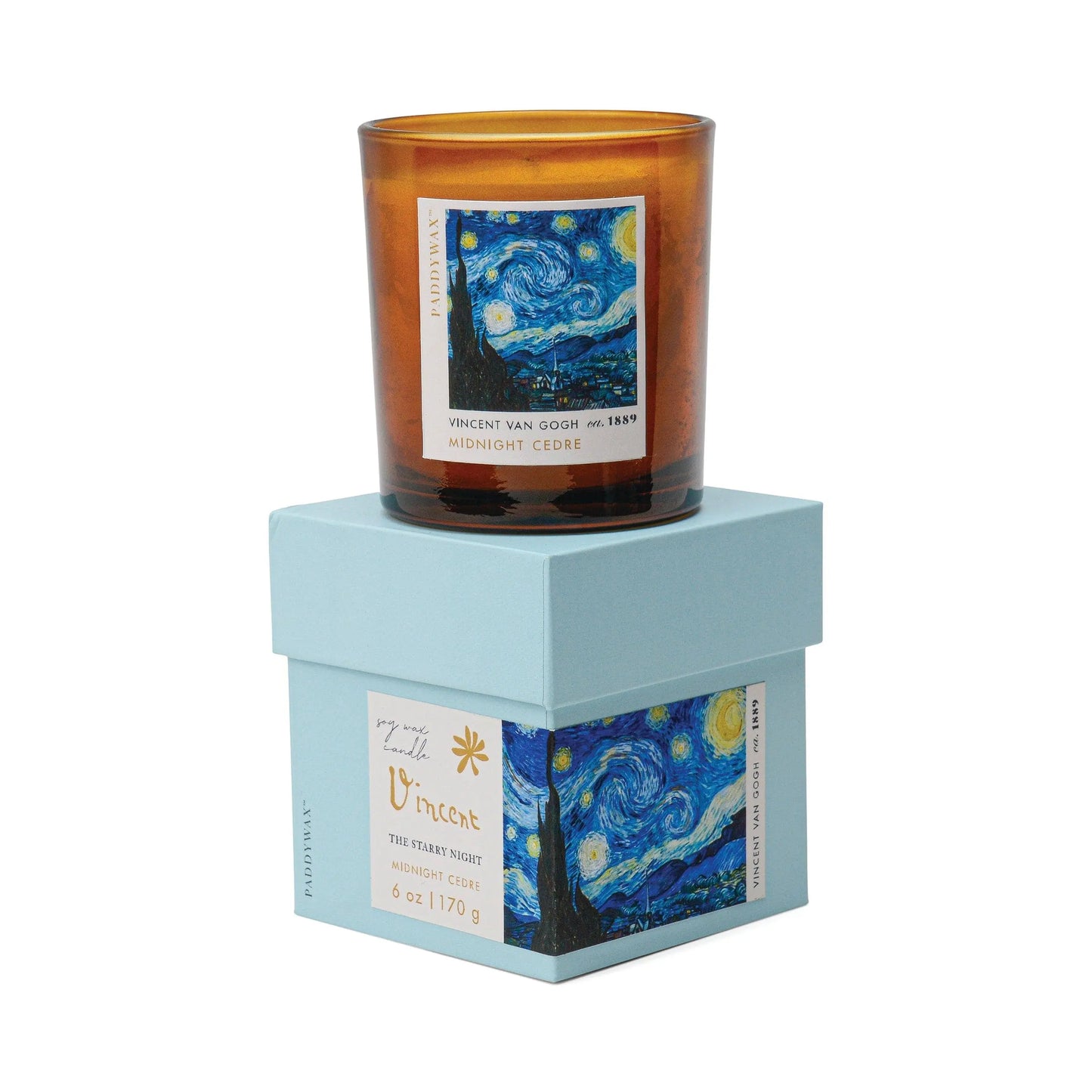 The Impressionist Candle - Vincent Midnight Cedre, in amber glass, rests on a light blue box adorned with The Starry Night print.