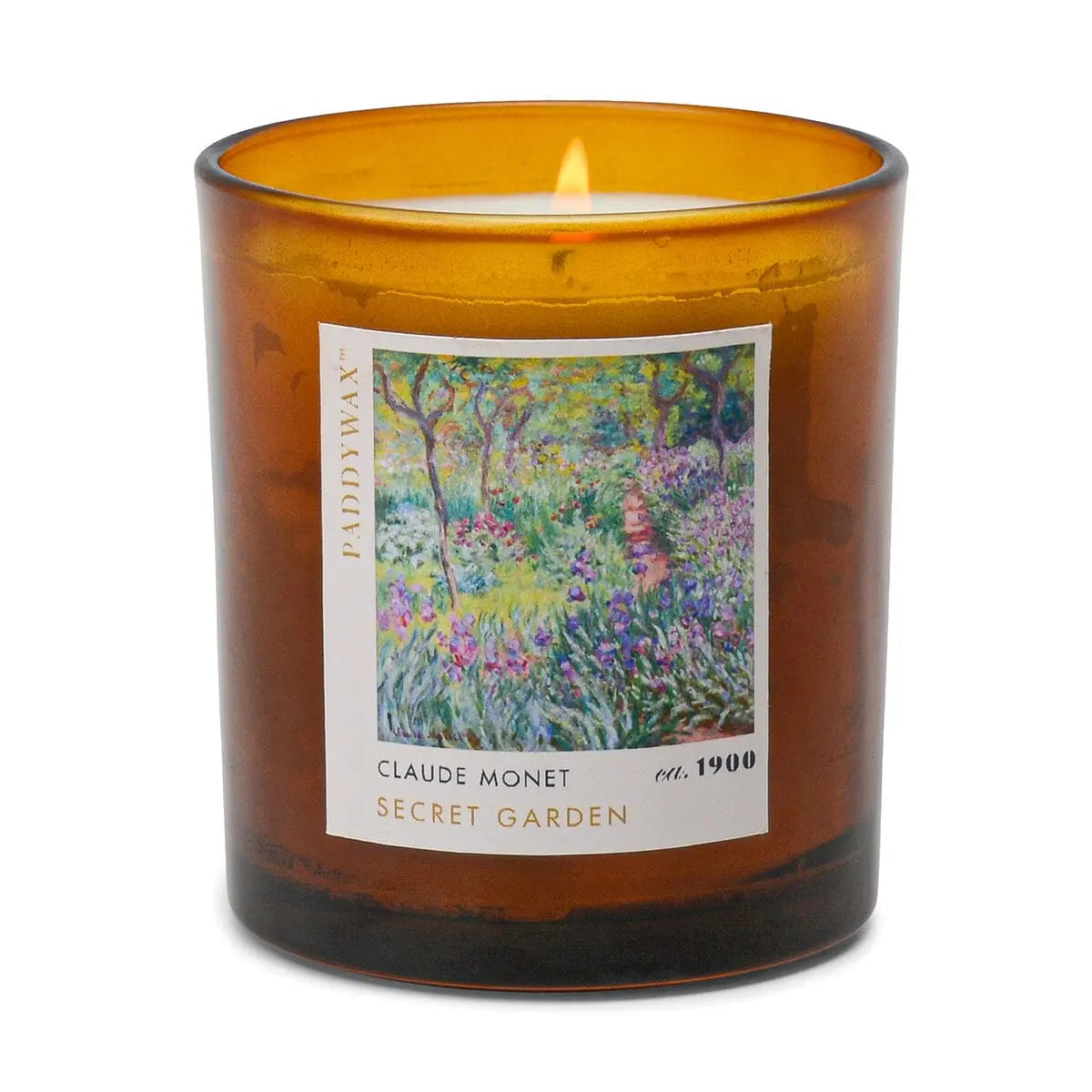 The Impressionist Candle - Claude Monet Secret Garden is a lit brown glass candle featuring a floral painting on the front that embodies the spirit of Monet’s art.