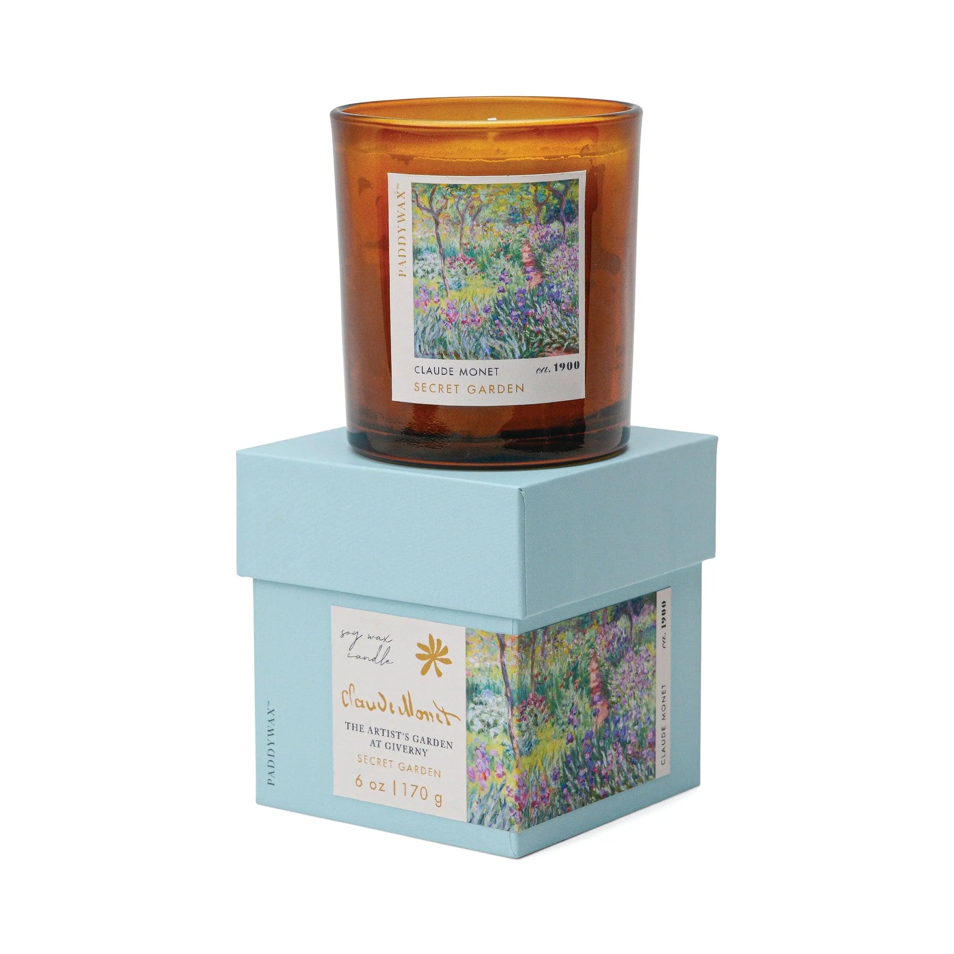 The Impressionist Candle - Claude Monet Secret Garden is a brown glass candle featuring Monet’s art on its label. It comes in a light blue box with matching artwork. This collection’s candles and diffusers create an artistic ambiance.