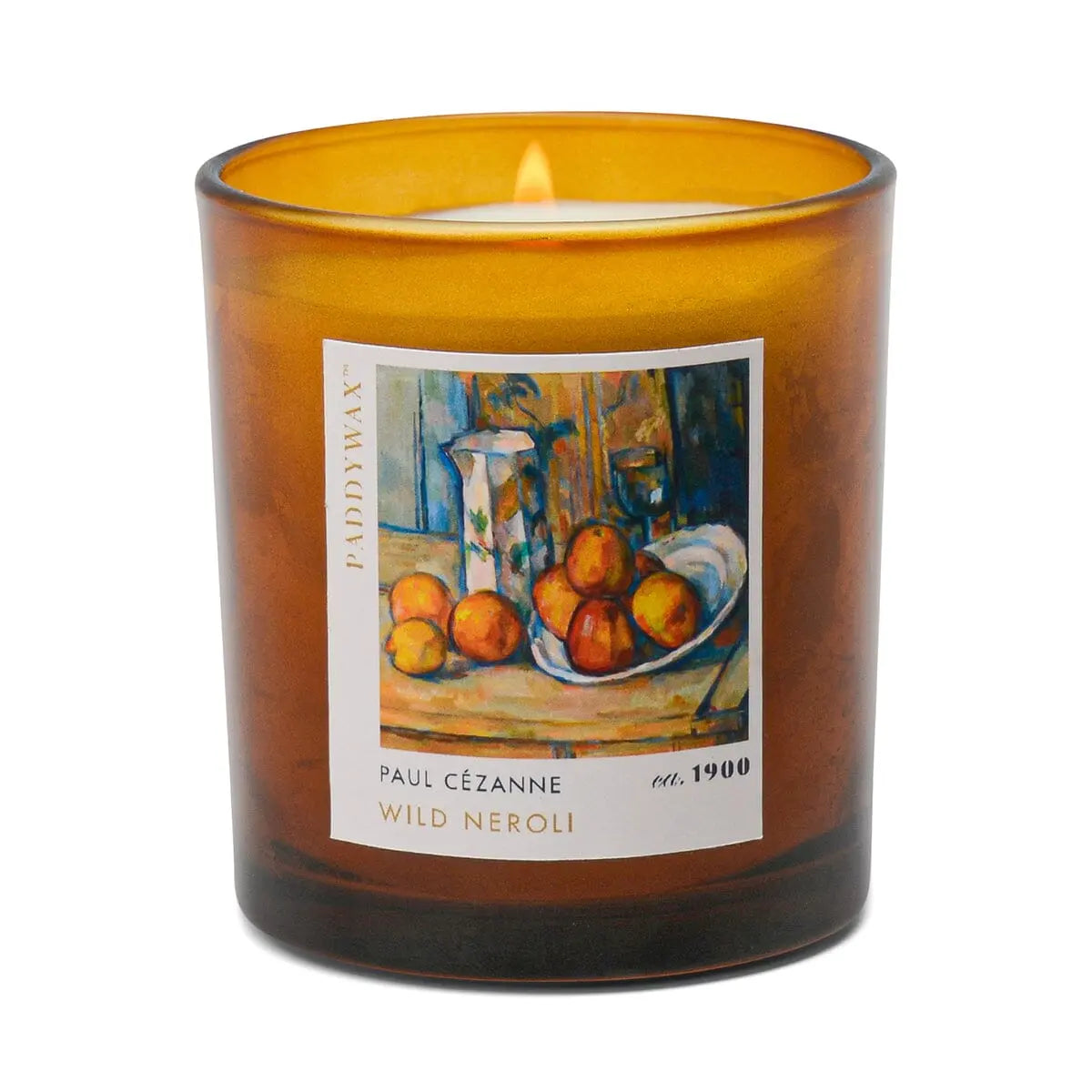 The Impressionist Candle - Cezanne Wild Neroli features an amber glass with a burning flame and still life fruit and vase label, honoring Cézanne—ideal for Impressionist art candle lovers.