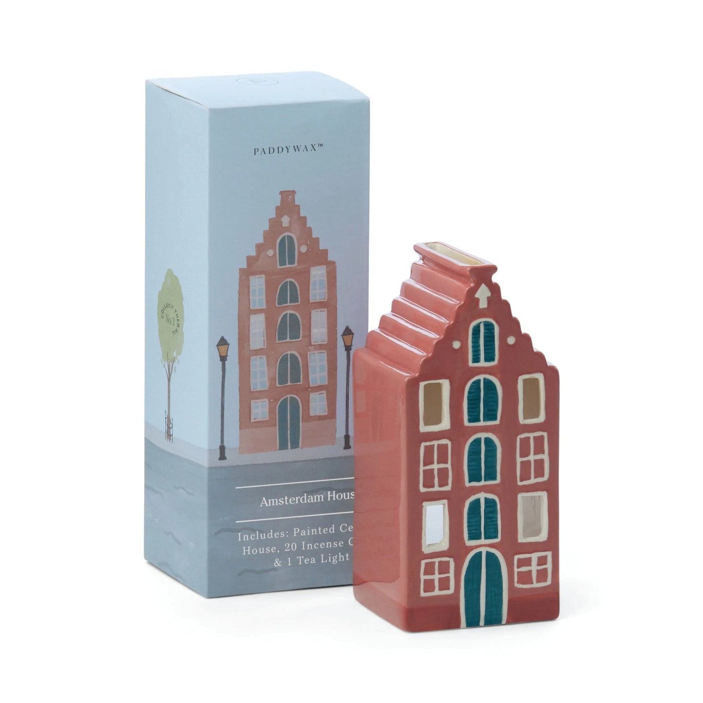 A ceramic Amsterdam House incense holder, inspired by city architecture, stands beside its box featuring a matching illustration and labeled Number 02 of a Collectible Series | The Amsterdam House.