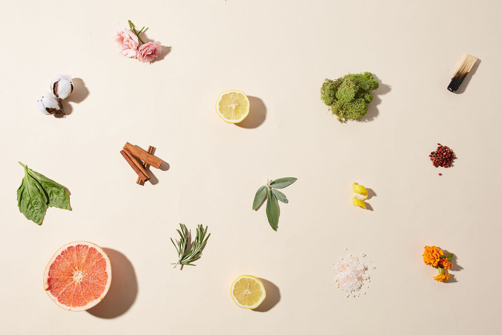 Candle ingredients spread out on cream background