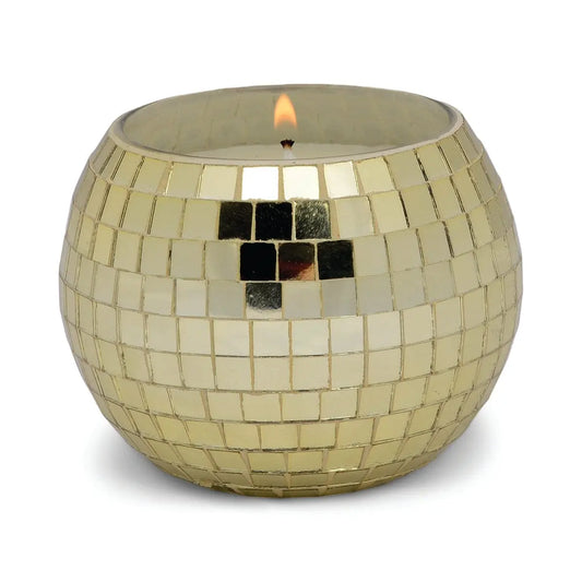 The Magique Green Disco Ball - Copal & Myrrh candle glows in a hand-crafted, round gold mosaic glass holder with tiled pattern, displayed on a white background—an elegant touch for your home décor.