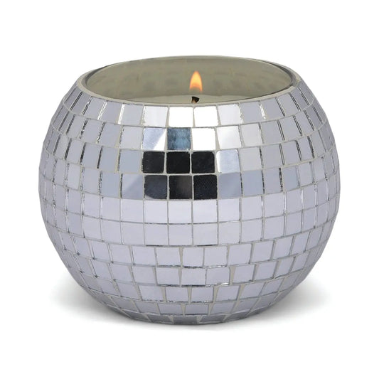 The Magique Green Disco Ball - Sparkling Bergamot features a lit candle inside, covered in small, reflective silver mosaic tiles—perfect for bringing mirror ball candle style to your home decor.