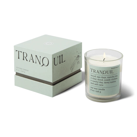 A light green Paddywax box and glass candle, both labeled Mood Collection 8oz - Lush Palms Tranquil, evoke serene vibes with white wax interiors—perfect for creating a tranquil mood.