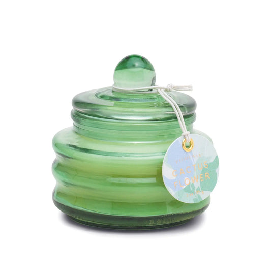 A green ribbed glass jar with a rounded lid and white string tag labeled “Cactus Flower,” the 3oz Beam candle evokes a fresh spring scent—ideal for gifting or as a unique jewelry box after use.