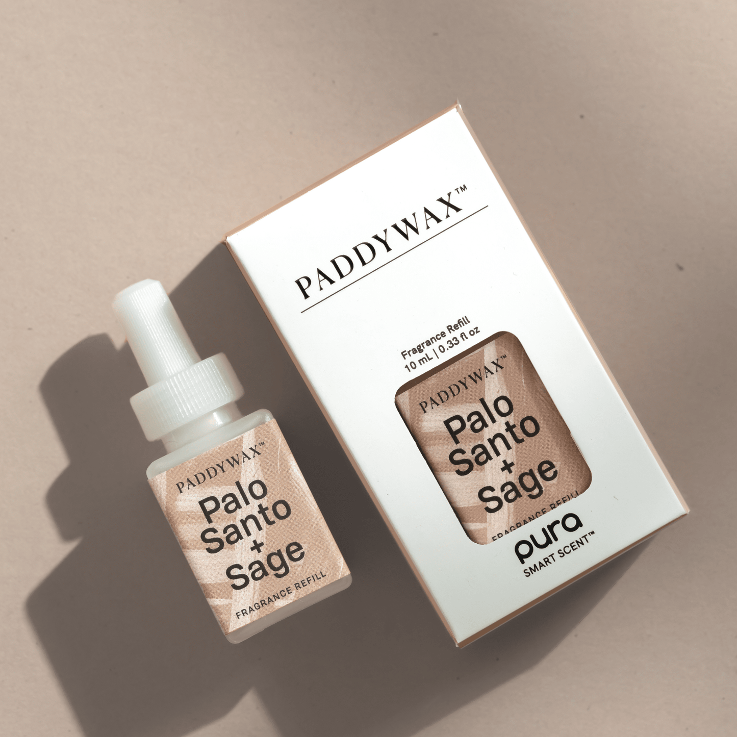 Paddywax Palo Santo + Sage fragrance refills for Pura resting on a table top