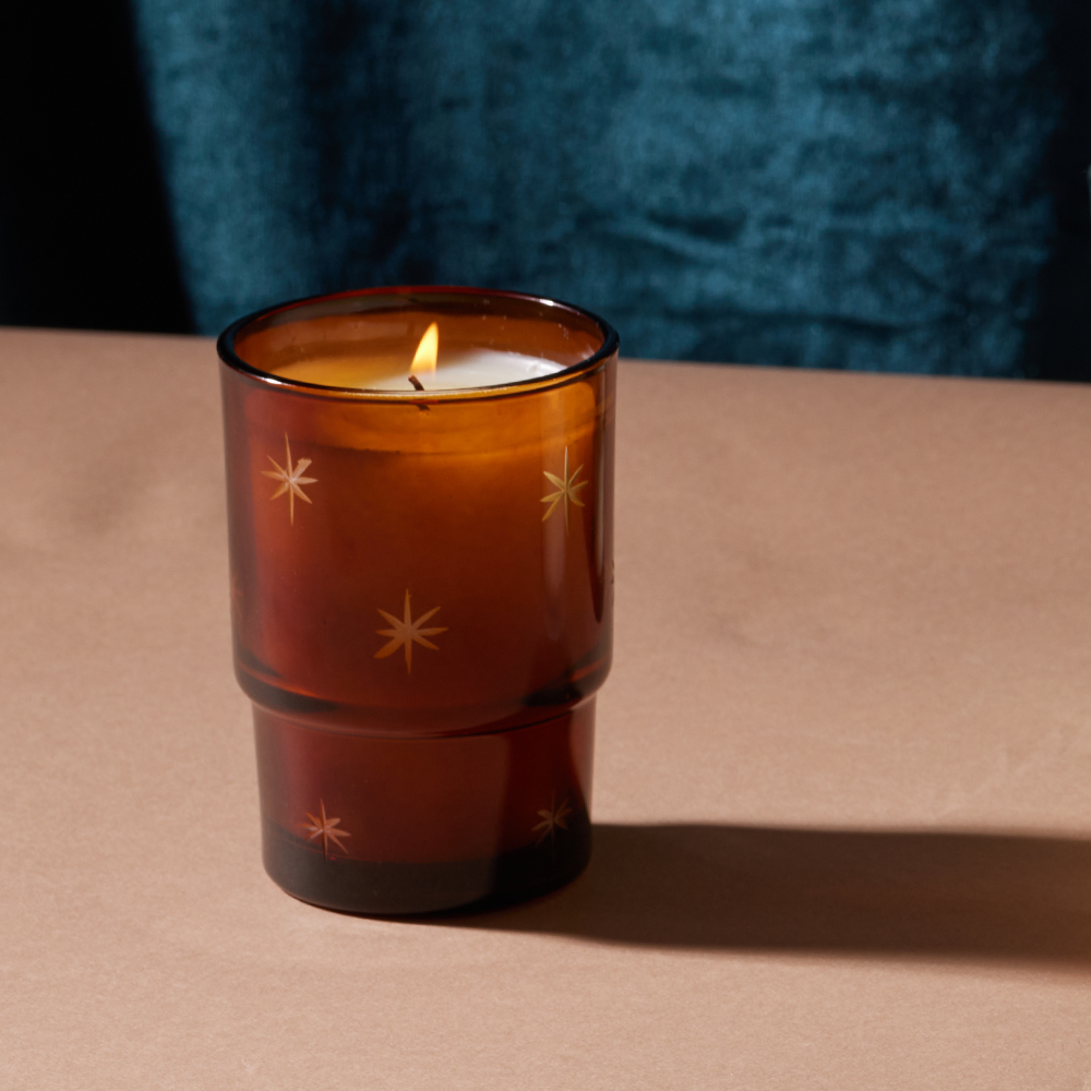 Amber brown candle with white soy wax burning - glass features etched stars