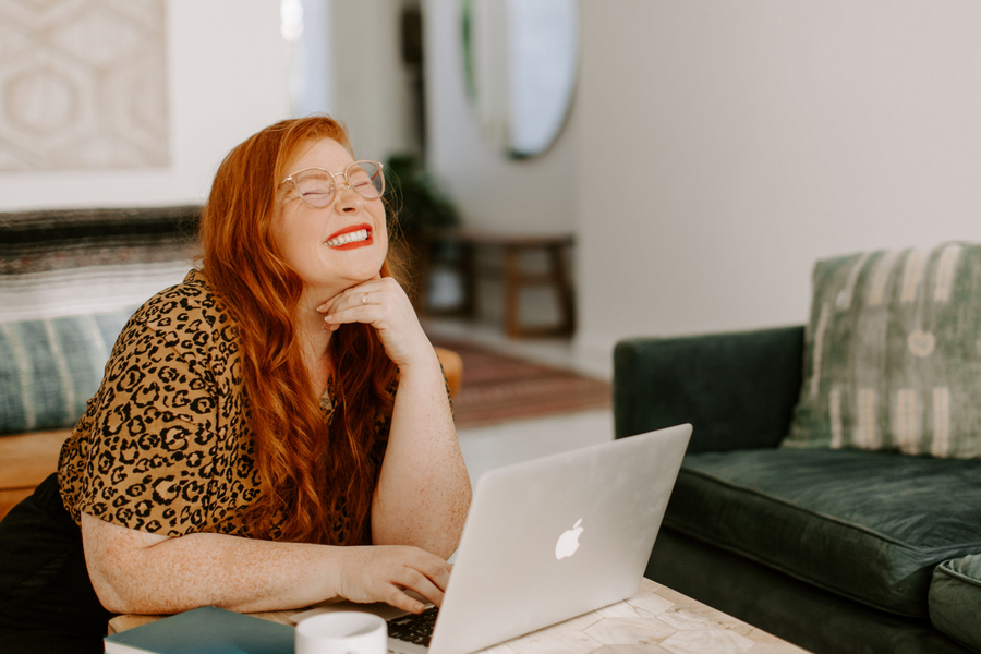 Woman smiling in front of computer
