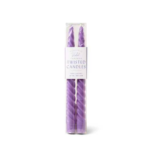 A clear box displays two Violet Twisted Taper Candles, each 10 in (25.4 cm), ideal for dining table or mantel decor.