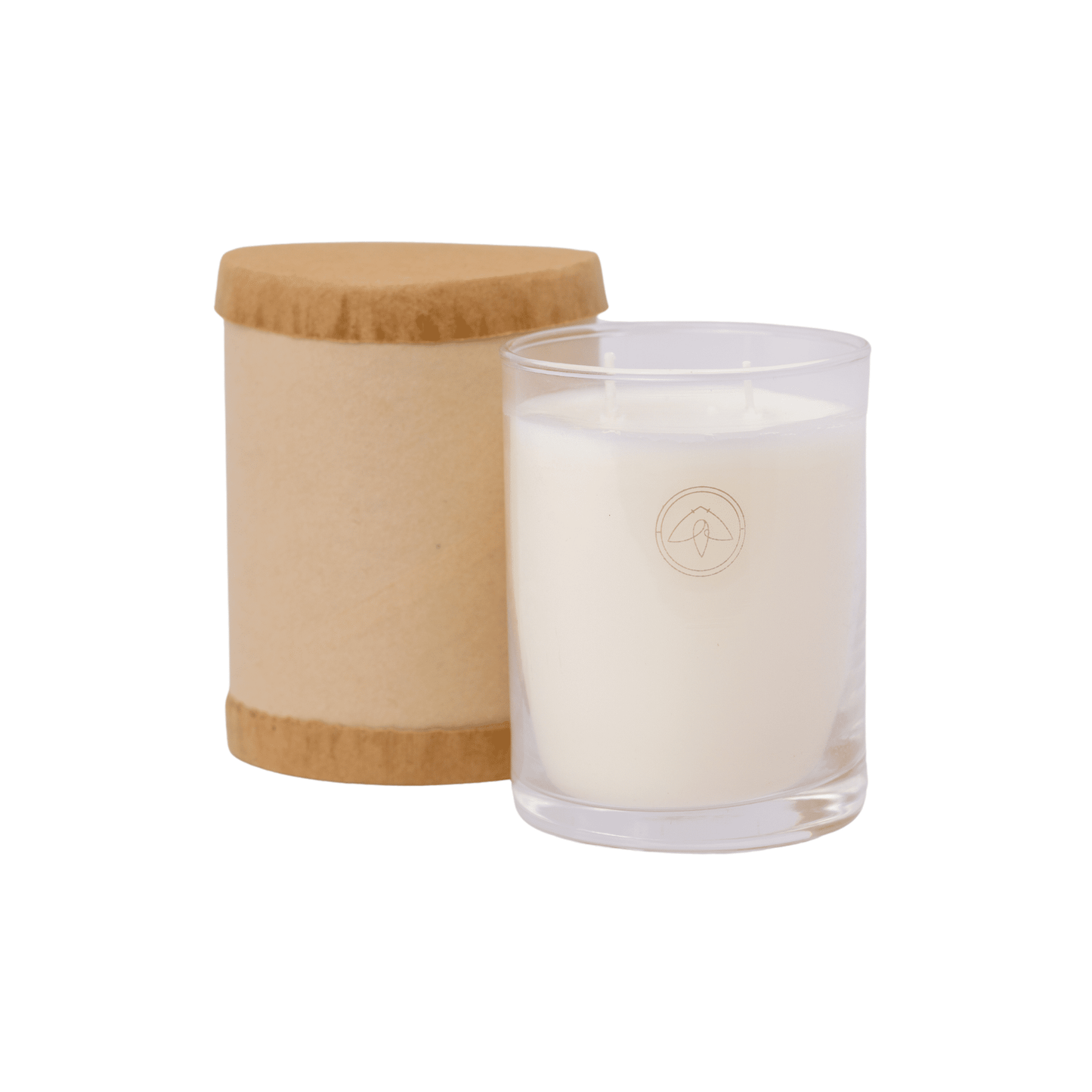 Clarity Candle in a clear glass vessel next to the paper tube it arrives in