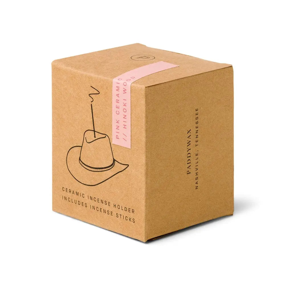 brown box packaging with outline of the ceramic cowboy hat holding an incense stick