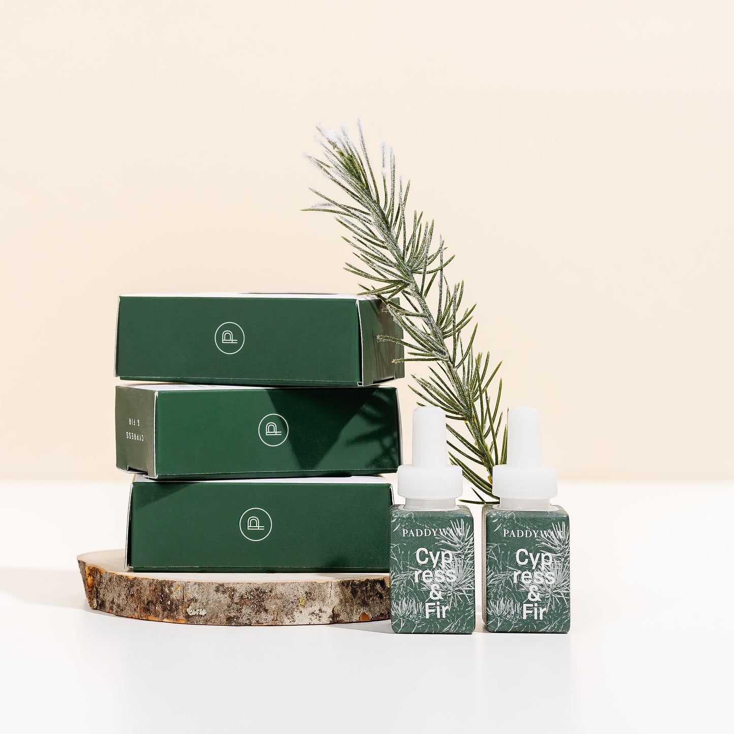 Cypress + Fir replacement fragrance pods for the pura device. Shown with a sprig on fir tree
