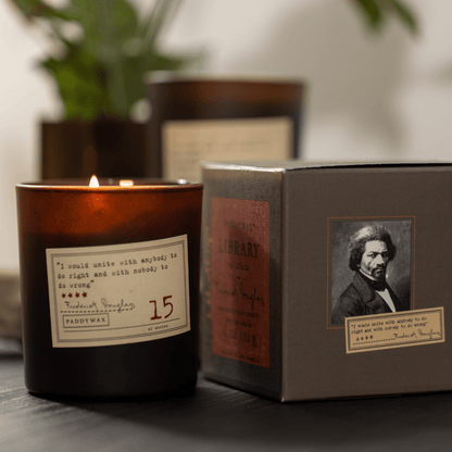 Library 6 oz. Candle - Frederick Douglas next to box on a table top 