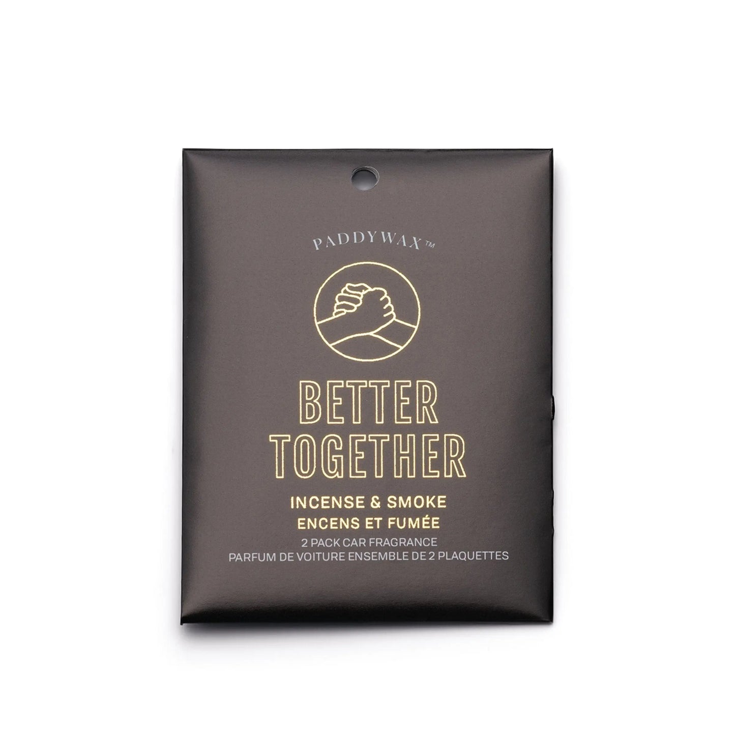 The Impressions Car Fragrance - Incense + Smoke Better Together by Paddywax comes in a black packet with clasped hands artwork, offering memorable incense and smoke scents for your car.