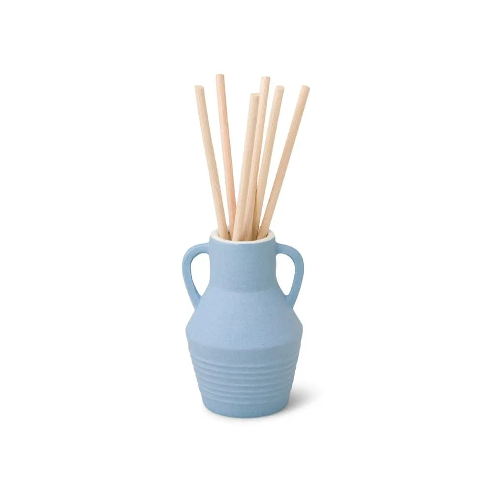 The Santorini 4 fl oz. Diffuser - Rosemary Sea Salt features a small blue vase with two handles, filled with light wooden sticks that stand upright as a stylish fragrance diffuser against a white background.