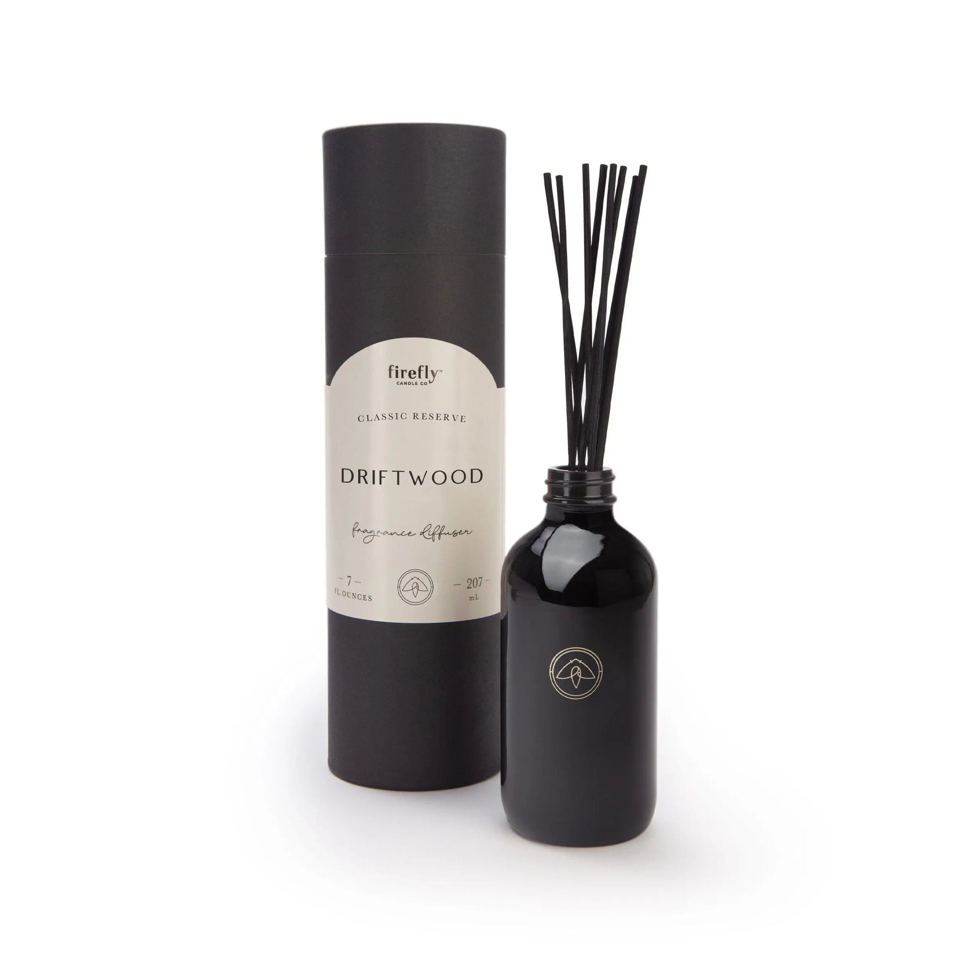 The Black Diffuser - Driftwood features a black bottle with fragrance sticks and a matching cylindrical container, providing a luxurious, flameless scent experience.