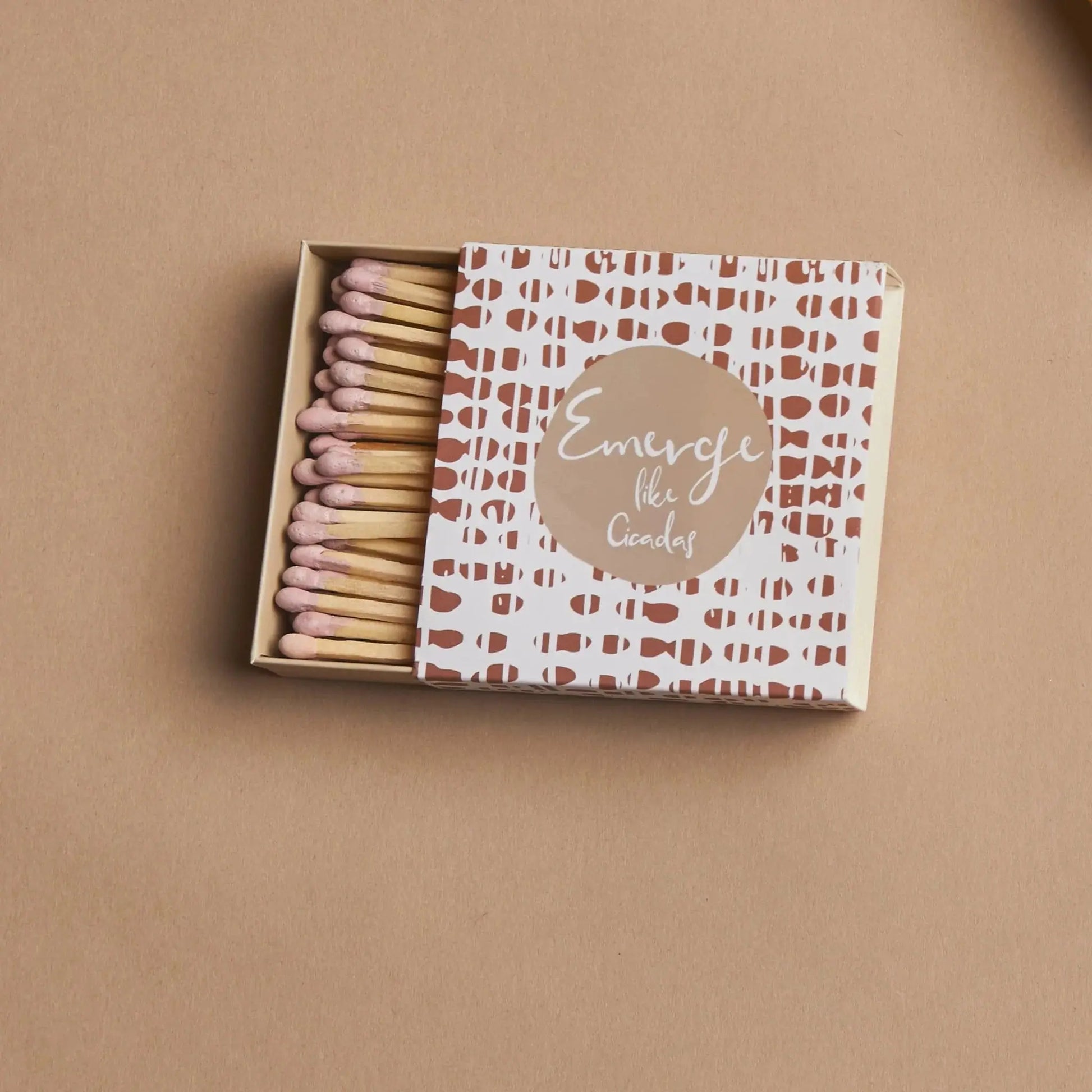 Terrace Matches - Emerge Like Cicadas: An open box of pink-tipped safety matches in a geometric brown and white box featuring “Emerge like Cicadas”—ideal for lighting candles or adding a special touch to any moment.