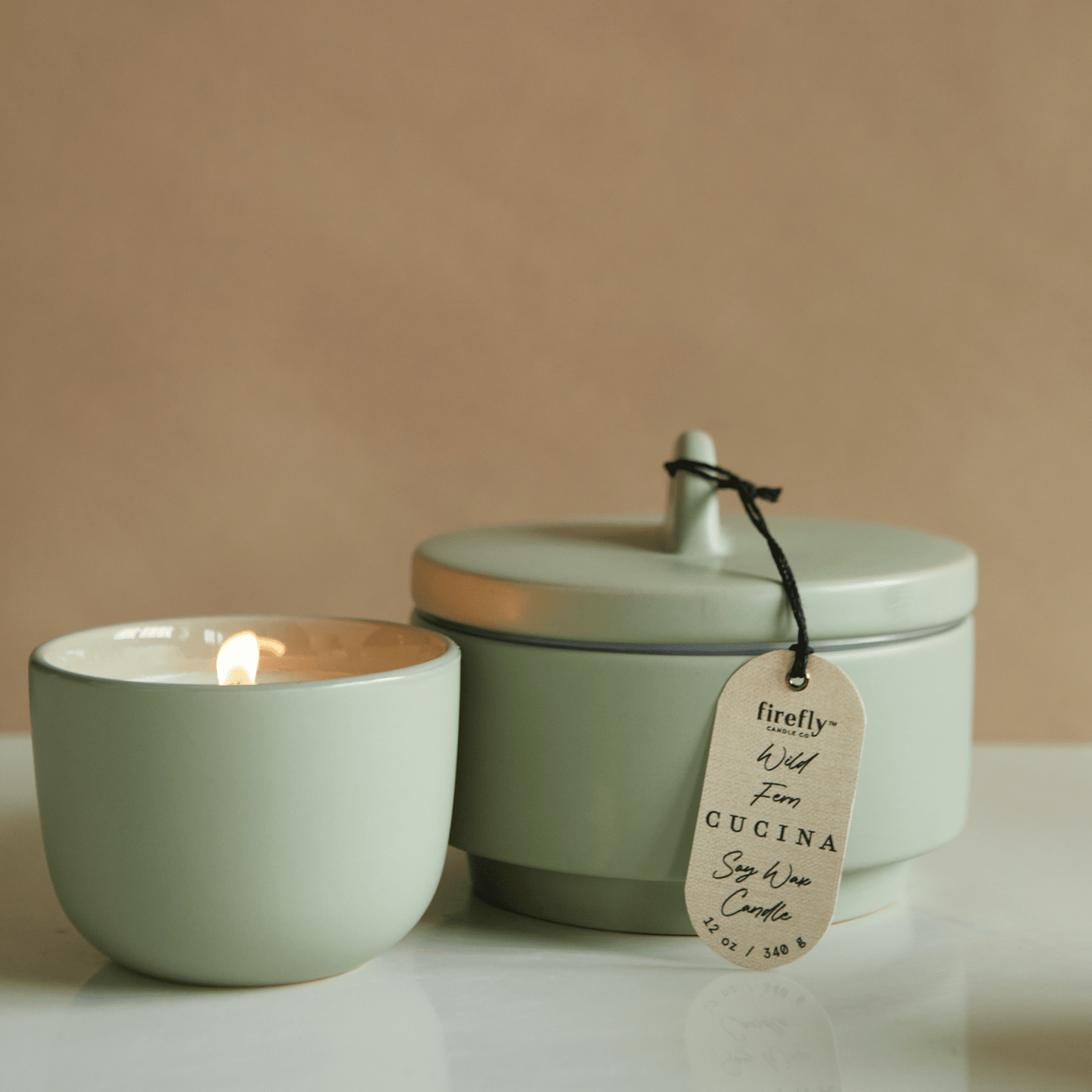 Wild Fern Cucuina candle on tan background and counter