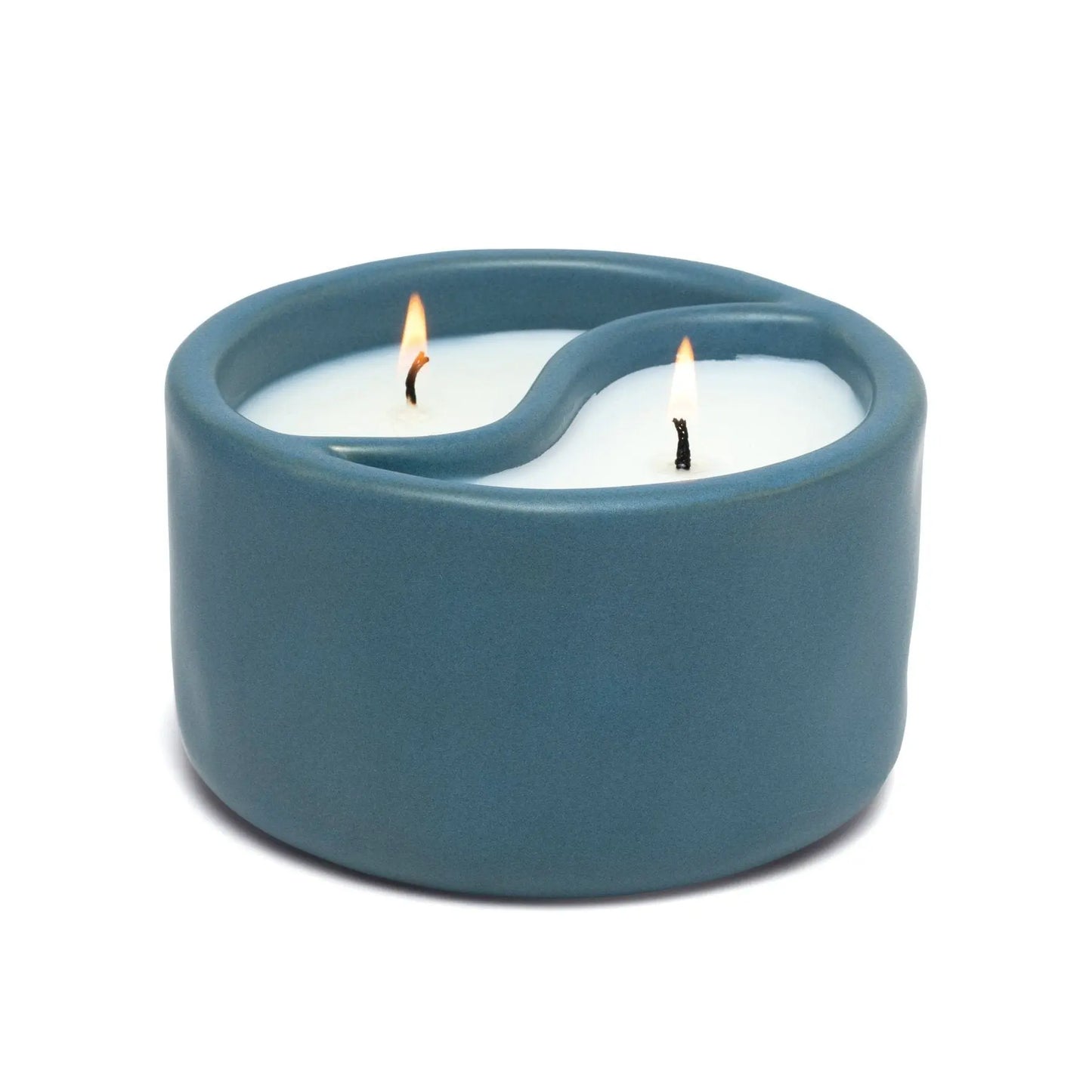 The Yin-Yang 11 oz Candle - Sea Moss + Sage features a blue ceramic holder with white wax and two wicks, offering calming fragrances to promote inner peace in your space.