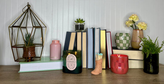 Cactus Flower collection of candles on a wooden shelf with books and plants