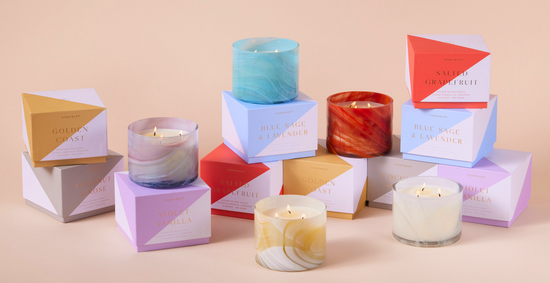 Whirl candle collection - colorful glass candles with white soy wax and colorful quality boxes in the background for gifting