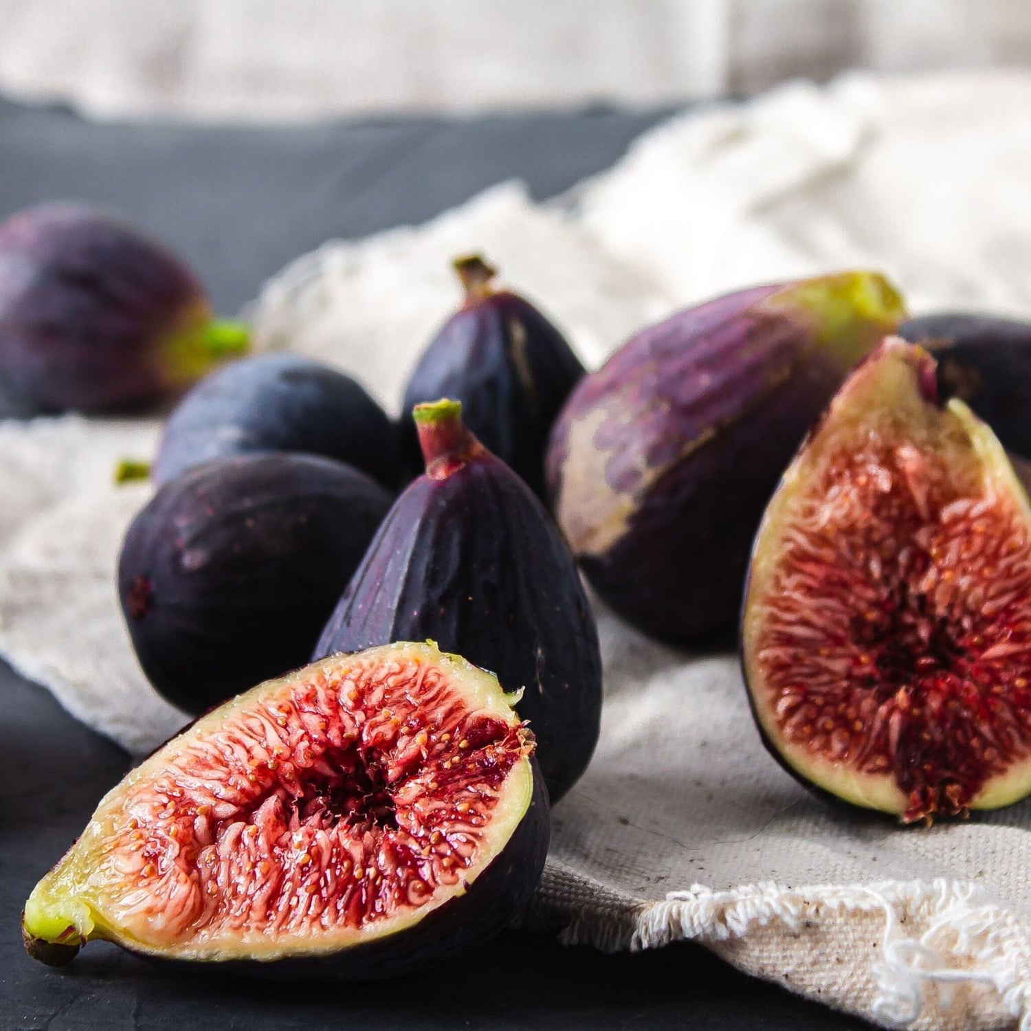 whole and split figs on white canvas 