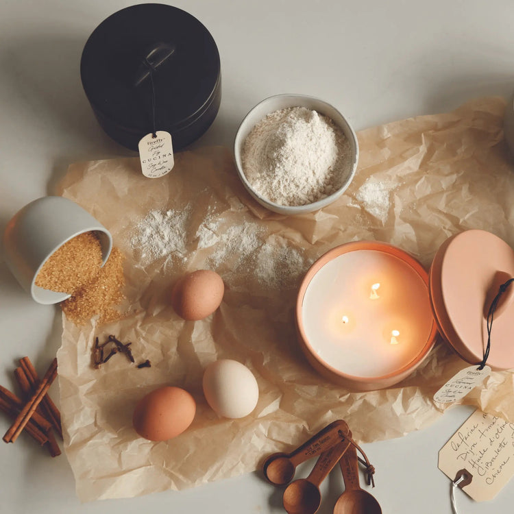 Cucina collection candles on counter with kitchen items and food