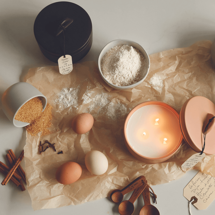 Cucina collection candles on counter with kitchen items and food