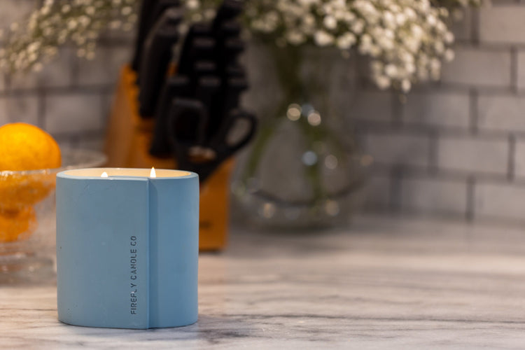 Cirque canlde on countertop with vase and knifeblock in background