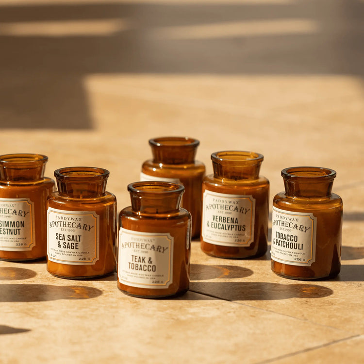Apothecary signature scent candles on tile