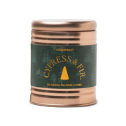 The Cypress & Fir Incense Cones come in a rose gold tin featuring a green forest-themed label design. Inside, you'll find 60 green incense cones by Paddywax, perfect for anyone who enjoys the soothing scent and tranquil atmosphere created by incense.
