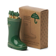 Wellington Boot Matches - Dark Green: A green ceramic boot-shaped match holder comes with safety matches, placed next to a brown box labeled Ceramic Match Holder featuring a matching illustration of the unique boot design.