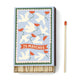 A Dopo Flower - 75ct Boxed Matches feature white doves and red flowers on the lid, ideal for lighting your A Dopo candle or recalling Mediterranean travels. Shown with a single red-tipped matchstick.