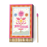A Dopo Sun - 75ct Boxed Matches features vibrant floral and celestial cover art. Includes 75 safety matches, each with a pink tip. Great for collectors of A dopo matchboxes or as a stylish tabletop accent.