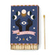 A Dopo Moon - 75ct Boxed Matches feature a celestial design with hands, an eye, moon phases, and stars—perfect for lighting your favorite candle or recalling Mediterranean travels. Shown here with a single matchstick.