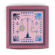 Balance - Pink Matches is a stylish pink matchbox labeled "Paddywax 100 jumbo matches" with a design of a balance scale holding the sun and moon, stars, and artistic hands—perfect as a unique candle accessory for your space.