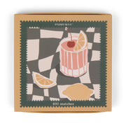 Paddywax’s Cocktail - Orange Matches jumbo matchbox features a checkered lid with a cocktail illustration, including a cherry, lemon slice, and wedges.