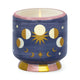 The A Dopo Moon Phases Candle—Jasmine & Rose features gold and white moon phases, stars, and a sun on blue ceramic, evoking Mediterranean travels while filling your space with bold jasmine and rose fragrance.