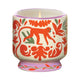 The A Dopo Jungle Candle - Coconut & Amber comes in a decorative ceramic holder with hand-painted folk art designs in red, green, and orange, featuring a charming monkey motif.