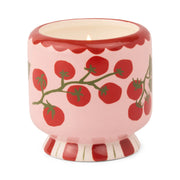 The Heirloom Tomato - A Dopo 8 oz Candle comes in a pink ceramic holder with red tomato vine designs, a striped base, and scalloped rim—perfect for displaying your favorite hand-painted or heirloom tomato candles.