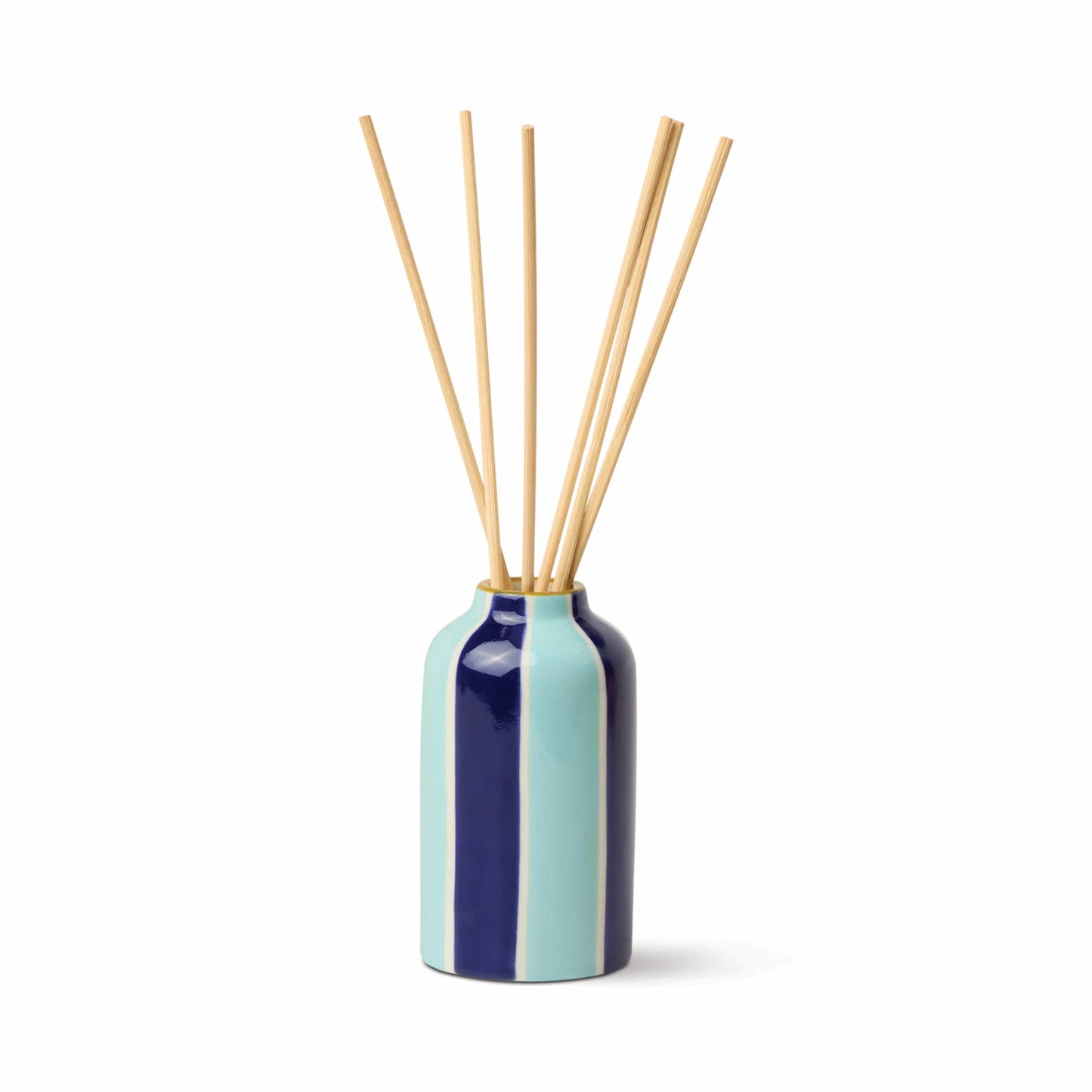The Incense & Smoke - A Dopo 4 oz Diffuser features a ceramic bottle with vertical blue and turquoise stripes, filled with long wooden reed sticks, against a plain white background.